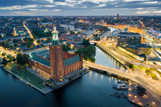 Aerial view of Stockholm city hall at night in Stockholm, Sweden Aerial view of Stockholm city hall and illuminated cityscape at night in Stockholm, Sweden kungsholmen town hall photos stock pictures, royalty-free photos & images