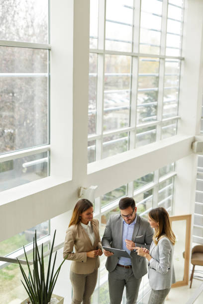 istock Young business people discussing ideas over digital tablet on staircase 1373260179