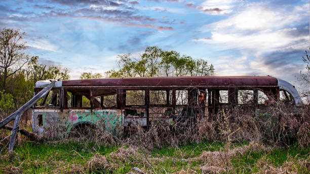 istock Old city bus dumped in a field 1373260180