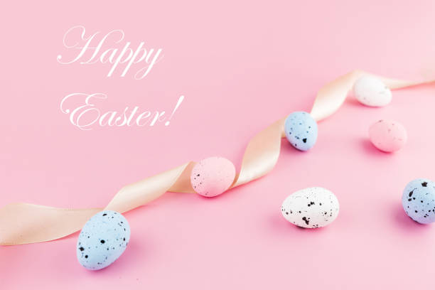 istock Text Happy Easter. Colorful easter quail eggs on pink pastel background with copy space. Minimal spring composition. Greeting card. Flat lay. 1373261591