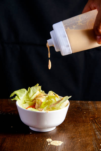 istock Cabbage with sauce in the white bowl and wooden background. 1373263276