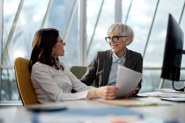 istock Female entrepreneurs talking about business reports in the office. 1373263302
