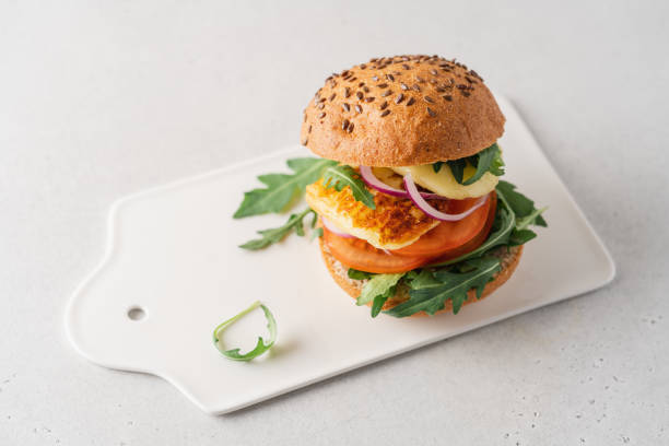 Halloumi burger with tomato, arugula and red onion