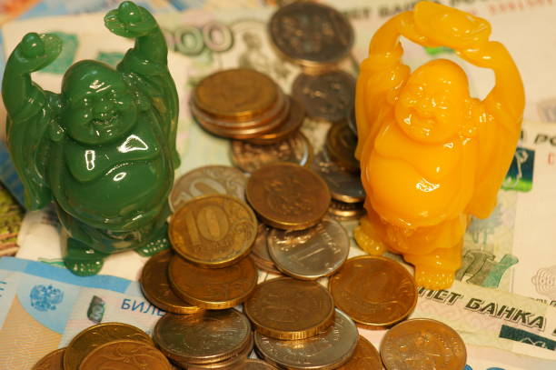 istock A Buddha figure with coins on the table. 1373265820