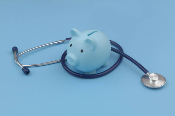 istock Blue piggy bank and stethoscope blue background. 1373265921