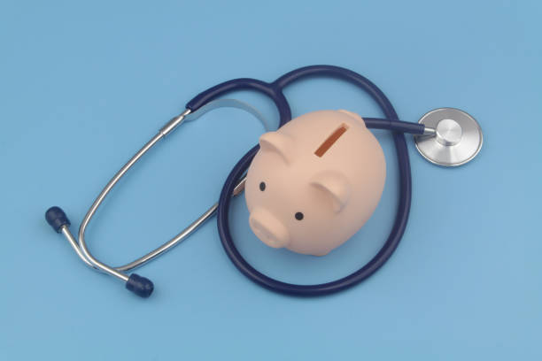 istock Piggy bank and stethoscope blue background. 1373265947