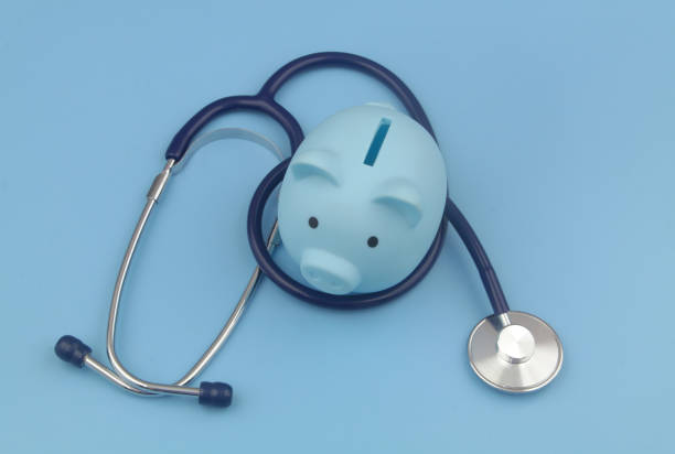 istock Blue piggy bank and stethoscope blue background. 1373265958