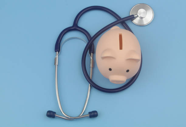 istock Piggy bank and stethoscope blue background. 1373265975