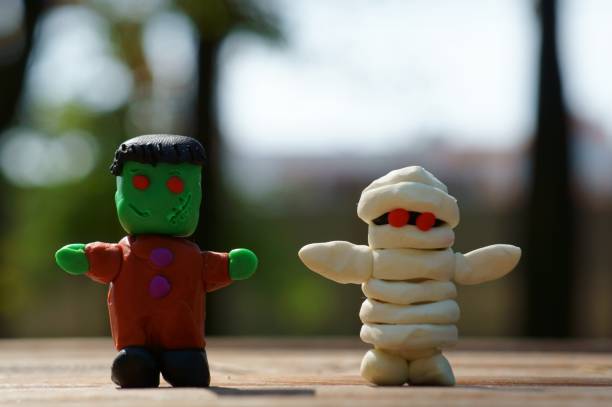 istock Funny Frankenstein and a plasticine mummy close-up. 1373265979