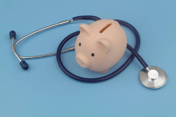 istock Piggy bank and stethoscope blue background. 1373265988