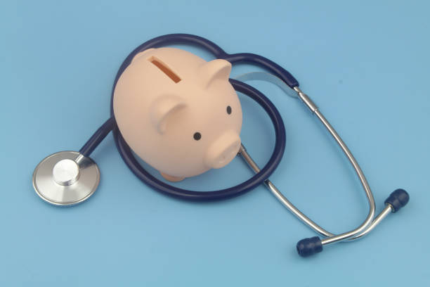 istock Piggy bank and stethoscope blue background. 1373265989