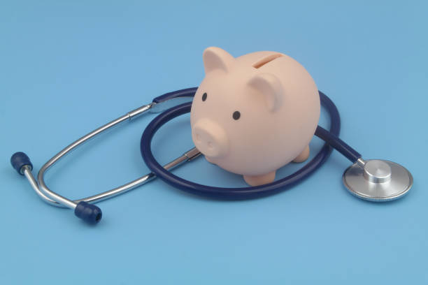 istock Piggy bank and stethoscope blue background. 1373266025