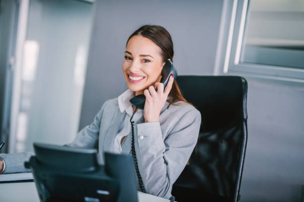 istock A friendly secretary answering phone call at modern office. 1373266087