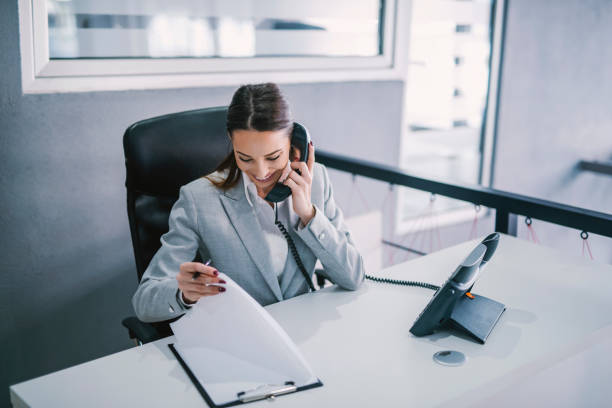an assistant schedules a meeting on the phone at modern office. - administrator telephone office support imagens e fotografias de stock