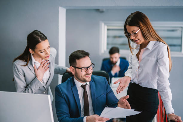 istock Businesspeople looking at badly written report at modern office. 1373267462