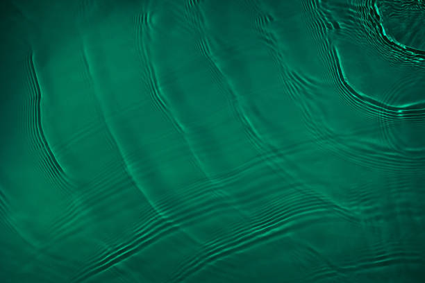 istock transparent dark green colored clear calm water surface texture 1373269960
