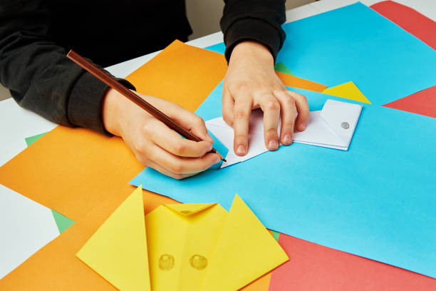 istock Boy making paper dog origami 1373271733