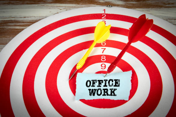 istock Office Work. Piece of paper and darts on a red target 1373272054