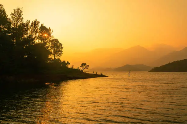 Photo of Beautiful sunset view with the peaceful lake and mountains as background