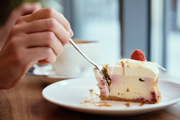 istock Woman have breakfast at cafe, eating raspberry cheesecake with coffee 1373275537