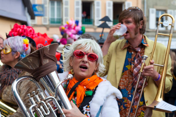 Sion, Switzerland - February 6, 2016: A men playing trombone in the carnival parade. Sion's carnival, Switzerland.