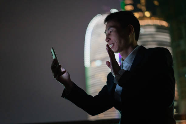 istock Night silhouette of man using smartphone 1373277155
