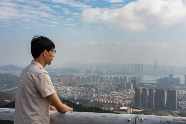 istock Asian man looking at city buildings 1373277202