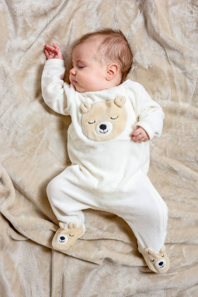 istock Baby lying on a bed and sleeping 1373279866