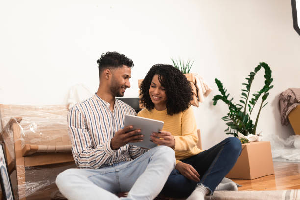 istock Happy couple taking a break while moving in and surfing the net 1373281107