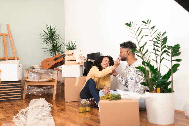 istock Happy couple taking a break for donuts while unpacking staff in their new home 1373281225