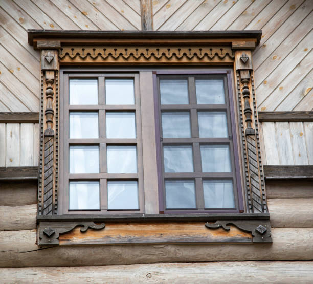 istock A beautiful square window with carved shutters. Rustic decoration, close-up 1373284710
