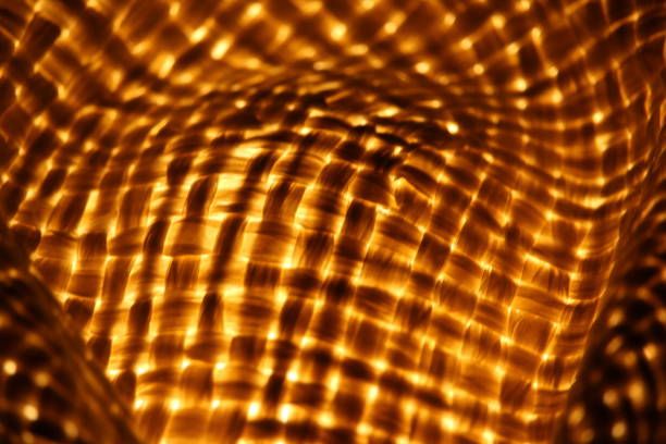 istock Texture image of light shining through a woven straw hat 1373286015
