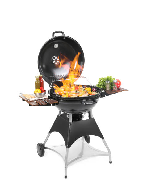istock Flaming barbecue grill with cooking meal on white background 1373287692