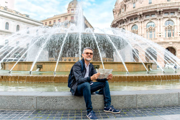istock Tourist man with map on Piazza De Ferrari 1373289040