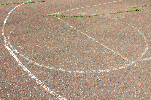 Abandoned asphalt basketball court. Close-up. Background. Texture.