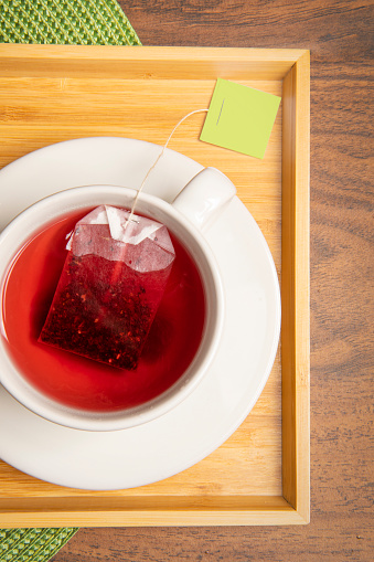 An overhead close up view of a fresh cup of hot tea.