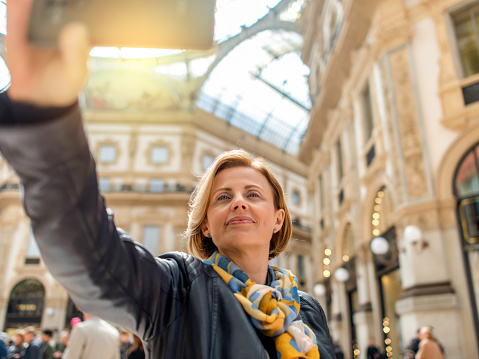 Woman making selfie inside the Galleria Vittorio Emanuele II