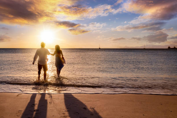 istock A happy couple enjoys a tropical beach during sunset time 1373290702