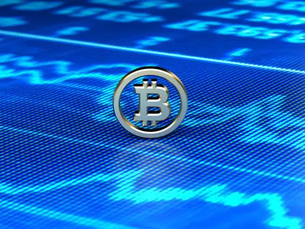 Bitcoin token over financial data on a blue screen