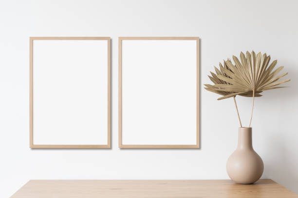 Two artwork mock-ups in interior design. Blank vertical picture frame stock photo