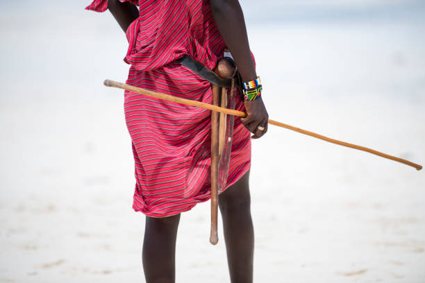 Zanzibar, Tanzania - January 02,2019: Masai warriors dressed in traditional clothes on sand beach of Zanzibar island.