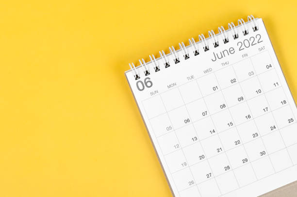 istock June 2022 desk calendar on yellow background with empty space. 1373293875