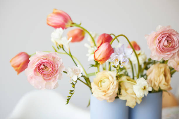 a modern spring bouquet of freesias, ranunculus and tulips in a beautiful vase - tulip vase flower spring imagens e fotografias de stock