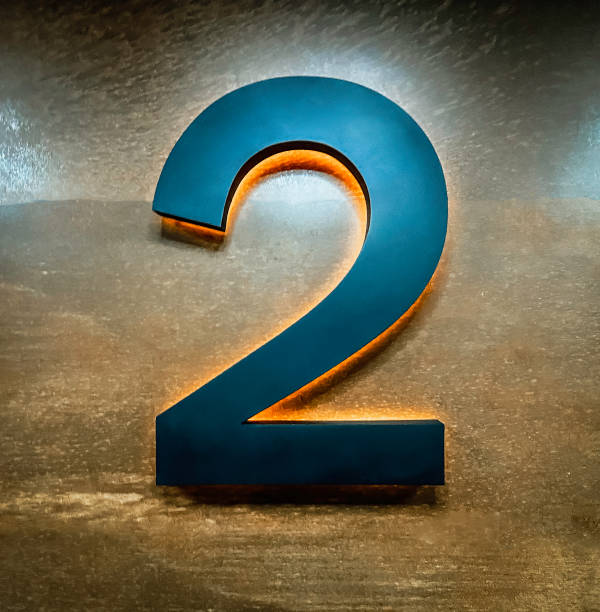istock Metal Number two 2 on a wooden wall 1373299863