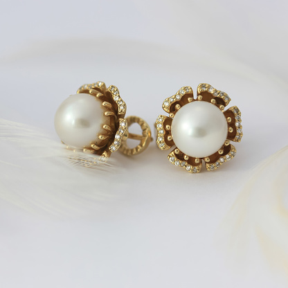 Pearl gold diamonds earrings. Close up jewelry fashion photo
