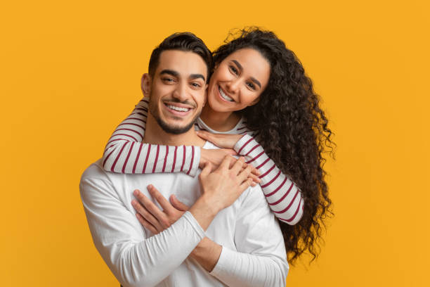 istock Happy Millennials. Beautiful Smiling Arab Couple Embracing And Looking At Camera 1373300617