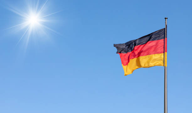 istock german flag in the wind with blue sky in background 1373301093