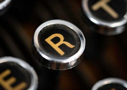 Gold coloured letter R on vintage typewriter