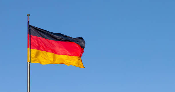 istock german flag in the wind with blue sky in background 1373302367