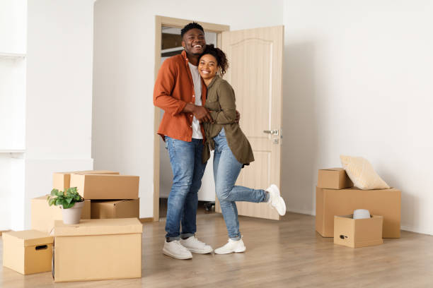 istock Black Spouses Hugging Standing Among Moving Boxes In New Home 1373302497